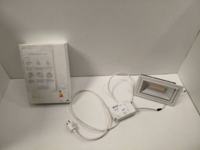 a white box with a remote control and a white box with an apple logo on it