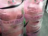 two pink stuffed animals wrapped in plastic bags on a table