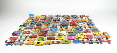 a lot of toy cars and trucks on a white surface