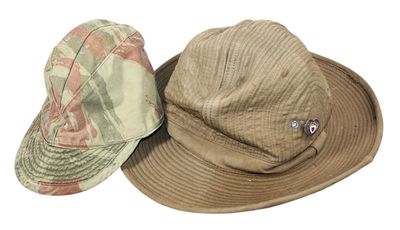 two hats are sitting on top of each other on a white surface