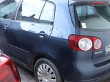 a blue car parked next to a red car in a parking lot