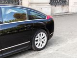 a black car parked on the side of the street