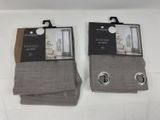 two pairs of gray socks with buttons on them on a white surface