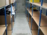 many shelves with boxes on them in a room