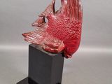 sculpture of a red fish on a black stand
