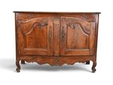 an old wooden cabinet with two doors and carvings on the front