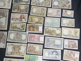 many different types of currency are displayed on a black surface
