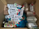 a cardboard box filled with bottles of water and other items