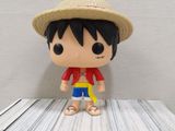 a small toy that is sitting on top of a stack of books