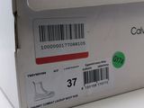 a box with a pair of white shoes in it