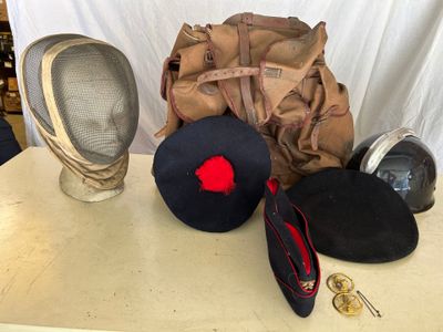 two hats, a backpack, and a helmet on a table