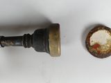 a metal pipe with a rusted cap next to it