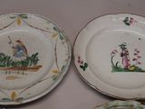 two plates with designs on them are sitting on a table