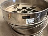 a metal bowl that is sitting on the floor