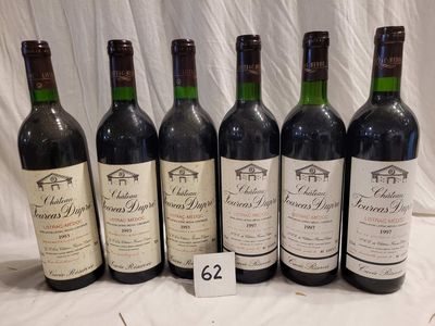 six bottles of red wine are lined up on a table