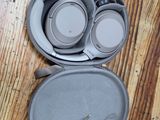 a pair of headphones in a case on a wooden floor