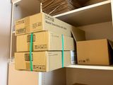 boxes are stacked on top of each other on a shelf