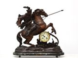 a statue of a man on a horse with a clock