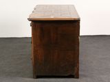 a small wooden cabinet with a tile top on the floor