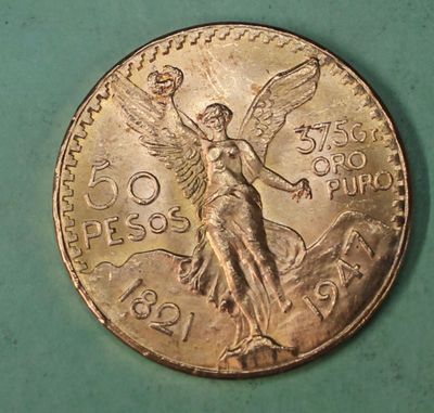 a close up of a coin on a table with a green background