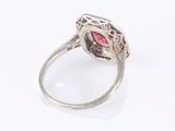 a close up of a ring with a pink stone in it