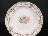 an image of a plate with a bird on it on a stand