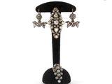an image of a pair of earrings sitting on top of a black stand