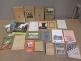 many books on a table that are sitting on the table