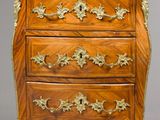 an antique wooden chest of drawers with marble top