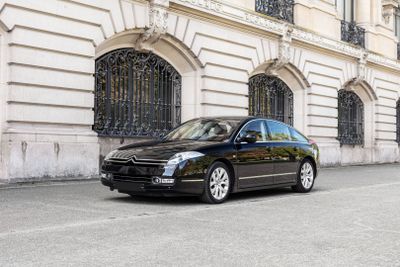 a black car that is parked in front of a building