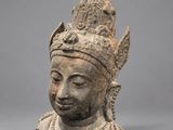 an ancient head of a woman with a crown on her head