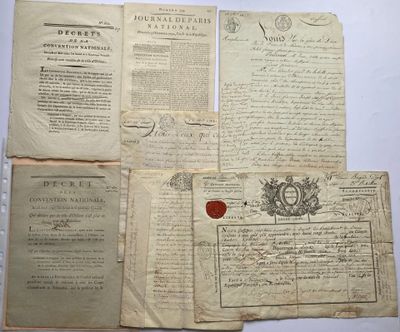 several old papers are sitting on a table with a wax seal