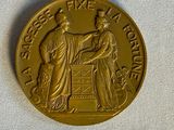 une image représentant une pièce d'or sur laquelle figurent une femme et un homme