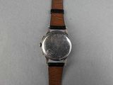 an image of a close up of a wrist watch on a white surface