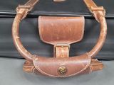a black suitcase with a brown handle and a brown handle