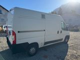 a white van parked in a lot near a house