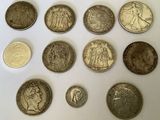 several coins are arranged in a circle on a white surface