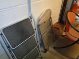 two folding chairs next to each other in a room