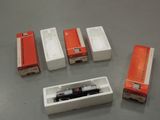 four boxes with a train in them sitting on a table