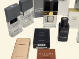 a lot of different perfumes and boxes on the table