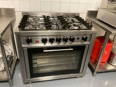 a stainless steel stove and oven in a commercial kitchen