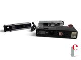two cameras sitting next to each other on a white surface
