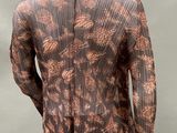 a mannequin mannequin wearing a brown and black patterned top