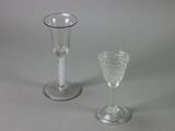 two wine glasses sitting next to each other on a table