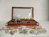 a wooden box filled with assorted items on a table
