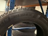 tires are stacked on a rack in a tire shop