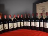 several bottles of red wine are lined up on a table