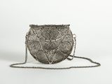 a silver purse with a chain around it on a white background