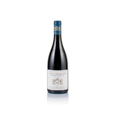 a bottle of red wine sitting on top of a white table