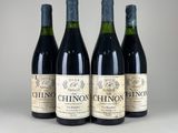 three bottles of wine are lined up on a table